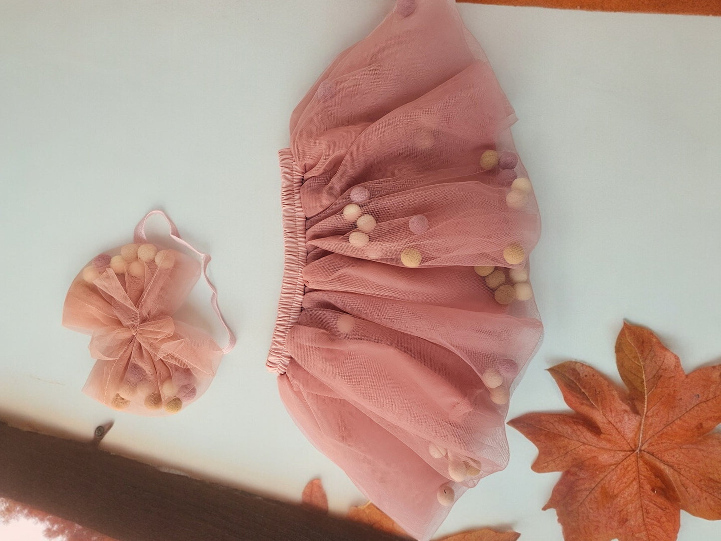 Peach skirt with pom pom